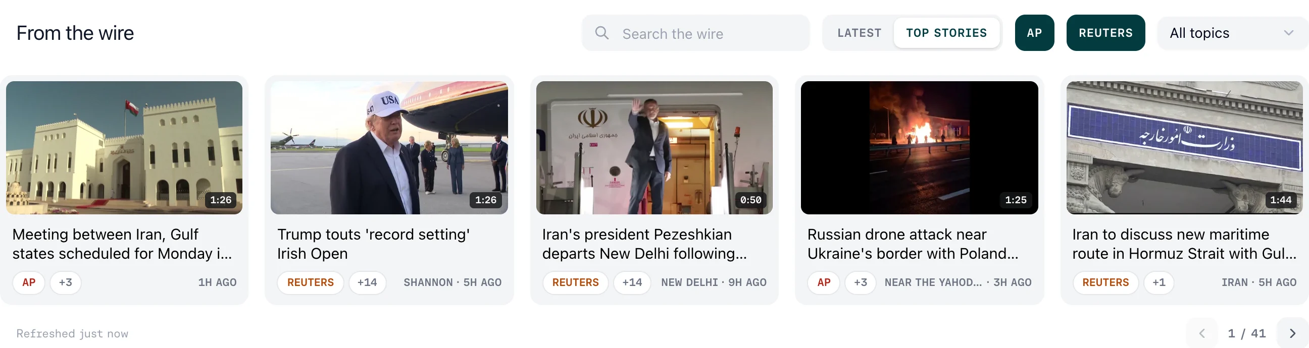 The From the wire feed: a Search the wire box, LATEST and TOP STORIES ordering, AP and REUTERS agency filters, an All topics dropdown, and a row of story cards each showing a thumbnail, duration, headline, agency badge, the count of other packages in the story, and where and when it was filed.